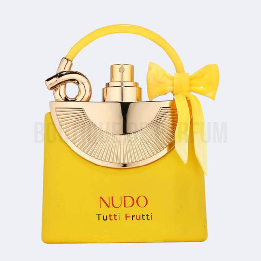 Yellow and gold Nudo Tutti Frutti perfume bottle with a bow on a white background